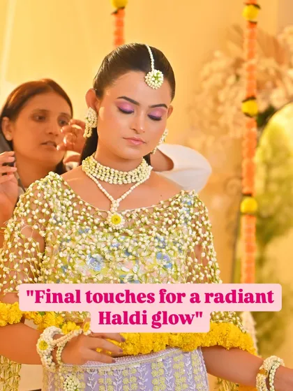 The final touches for a radiant Haldi glow. This shot captures me perfecting the bride's look, ensuring she is ready for her ceremony.