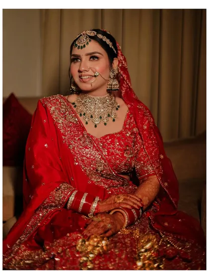 A happy, candid portrait of the bride. Her natural smile and the soft, warm lighting create a welcoming and beautiful image that captures her joy.