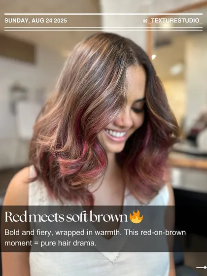 Red meets soft brown for some pure hair drama. This look combines a warm brown base with bold, fiery red pieces for a high-impact, edgy style.