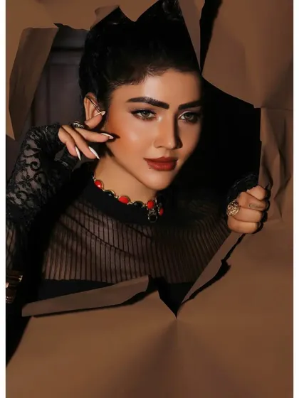 A creative and conceptual beauty shot, with the model peering through torn paper. This artistic approach is perfect for an editorial or a high-fashion makeup campaign.