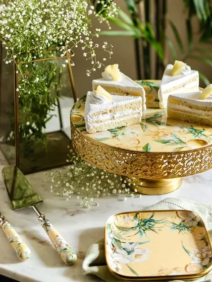 A celebration is a collection of sweet moments. Our Lisbon Lemon cake stand and platters are designed to make those moments shine. This image captures the joy of a summer birthday, where our serveware becomes the perfect stage for delicious treats, surrounded by fresh flowers and effortless style.