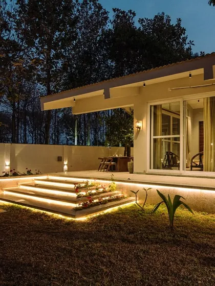 At the Amberle farmhouse, we stepped back and let the site dictate the design. This evening shot shows how the landscape lighting enhances the natural beauty, creating a perfect harmony between the built and natural environment.