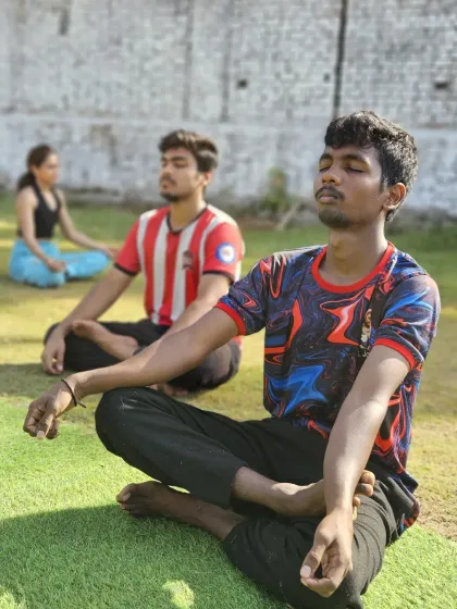 Athletes take a moment to center themselves with meditation at our outdoor park. Connecting with your breath is a key part of our training philosophy.