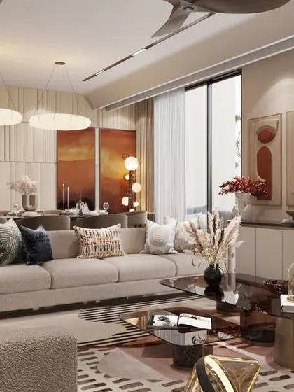 A wide view of the open-concept living space, where natural light floods in through large windows. We used a mix of plush sofas, textured rugs, and curated art to create a room that is indulgent yet inviting.