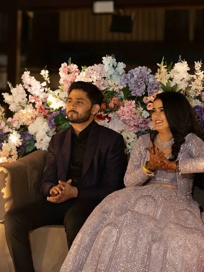 Another lovely shot of the couple at their Sangeet. The bride's makeup is flawless, ensuring she looks her best for these important photo moments.