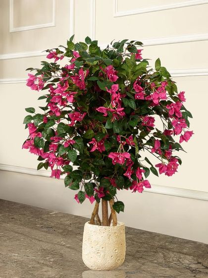 This lush artificial bougainvillea plant in a deep pink is perfect for adding a dense burst of color. It looks beautiful in a decorative pot on a balcony, patio, or in a sunlit corner.