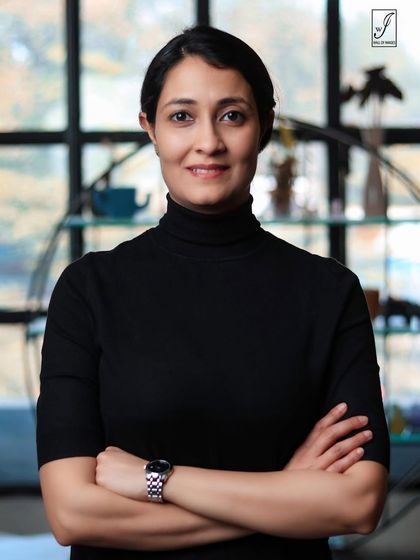 A clean and simple headshot with the subject's hair pulled back, offering a different, more formal look.