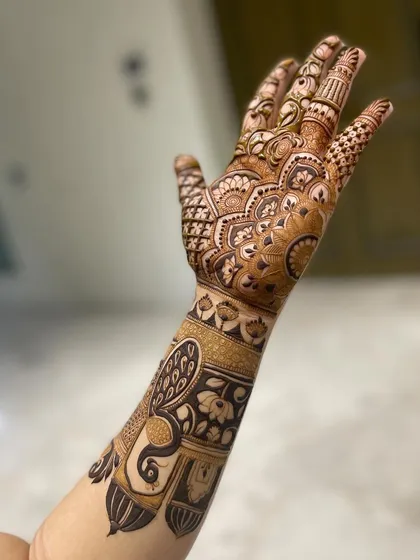 A single-arm shot showcasing a design with a large peacock motif on the forearm.
