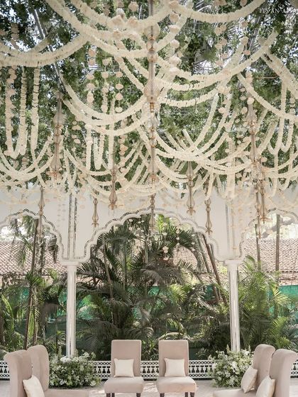 The mandap ceiling, decorated with cascading strings of tuberose (rajnigandha), creating a fragrant and visually stunning canopy.