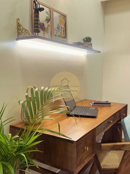 This image showcases the cozy study nook within the master bedroom, featuring a solid wood desk and a floating shelf with integrated lighting, perfect for work or reading.