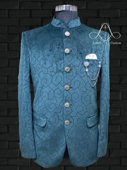 This is where fabric and design come together. A full view of my teal velvet bandhgala featuring a unique geometric pattern. It's a contemporary piece that feels both luxurious and distinctly stylish.