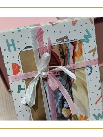 A beautifully packaged baby album, part of a larger gift set for a newborn.