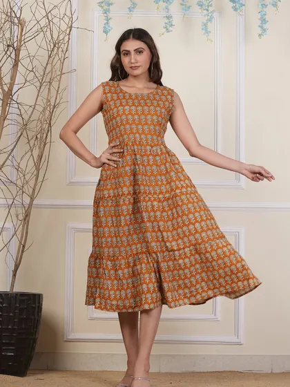An earthy mustard yellow tiered dress with a traditional bootie block print. Made from pure cotton, it's both comfortable and effortlessly stylish.