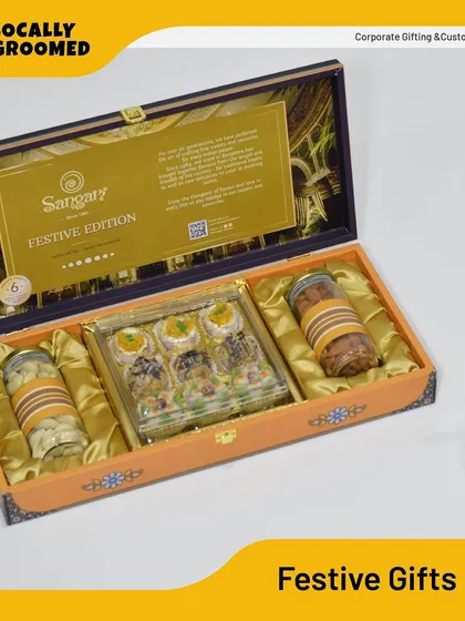 A luxurious festive edition gift box from Sangam. This hamper includes traditional Indian sweets and premium nuts, presented in an ornate box perfect for high-end client gifting during festival seasons.