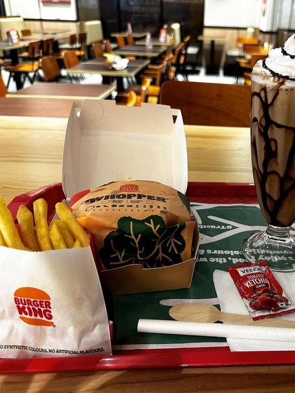 A satisfying meal tray from Burger King, complete with a Whopper, fries, and a shake. It's the perfect fuel for the road ahead.