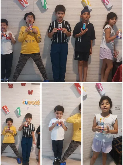 A group of happy kids showing off their robot creations. Our sessions are always interactive, and every child is encouraged to express themselves.