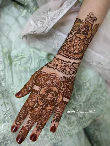 A beautiful rose-centric design with heavy details on the fingers and wrist. Perfect for a bride or any grand celebration.