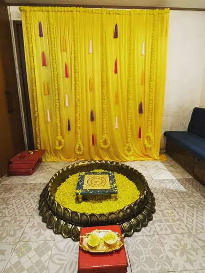 This large decorative brass urli is one of my most popular rental items for Haldi and Mehendi functions. Filled with flower petals, it becomes a beautiful centerpiece for your ceremony. I also provide the matching bajot (low stool).