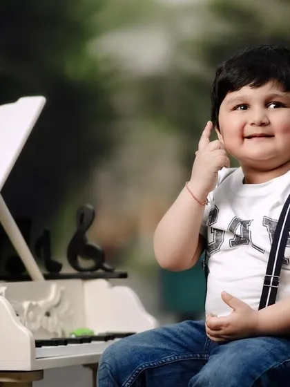 A happy three-year-old at his piano. It's wonderful to see how children's personalities shine during these fun, interactive photoshoots.