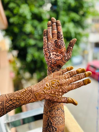 A creative angle showing off the intricate details of the bridal mehendi. The design is full of beautiful patterns and personal touches.