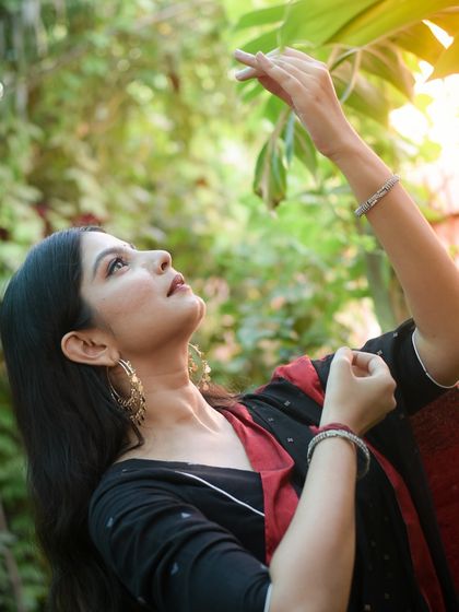 A profile shot looking up towards the light, captured in a natural, green setting. This portrait evokes a sense of hope and connection with nature.