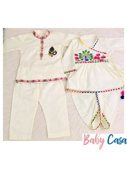 A classic twinning set for brother and sister. This combination of an embroidered kurta pajama and a matching angrakha-style dhoti set is perfect for any festive occasion.