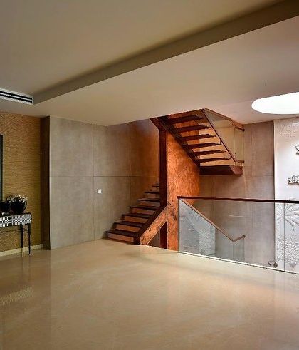 The upper landing is a spacious, gallery-like area, with the staircase and art wall serving as the main features.