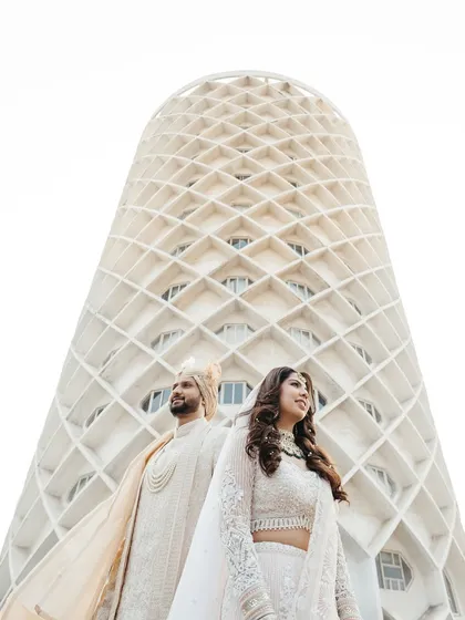 Your love story is a masterpiece, and it deserves a frame that is just as epic. I love finding unique perspectives, like using the stunning architecture of the venue to create a modern, powerful portrait that feels both grand and intimate.