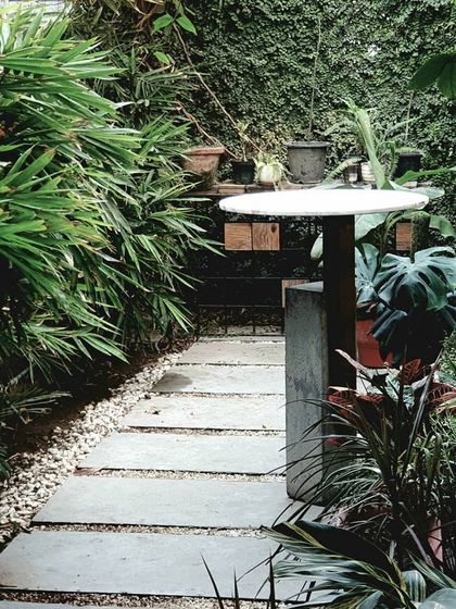The outdoor green area at our own studio serves as an open break-out zone. This lush space, with its stone pathway and vertical garden, brings a lot of positivity.