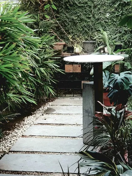 The outdoor green area at our own studio serves as an open break-out zone. This lush space, with its stone pathway and vertical garden, brings a lot of positivity.