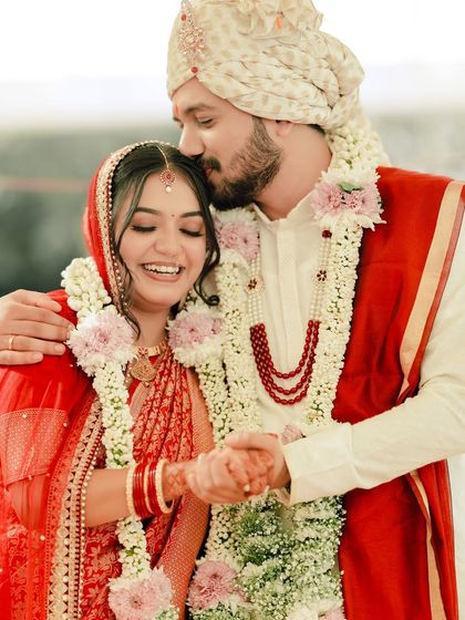 All about love. A tender forehead kiss captures the emotion of the day, with the bride looking effortlessly beautiful.