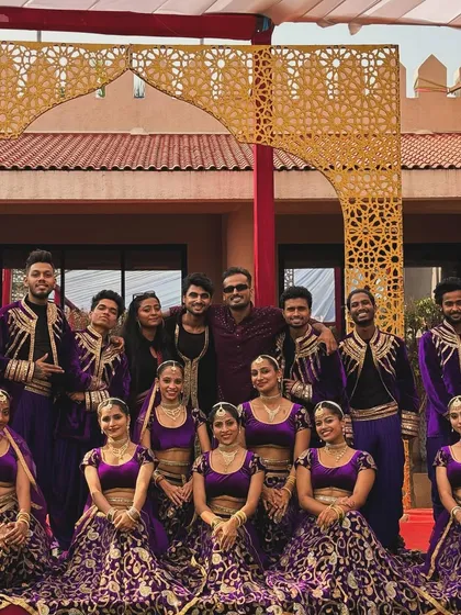 Another successful show with the best team. Posing in our ornate purple and gold costumes, this photo showcases the talented performers who bring our grand visions to life.