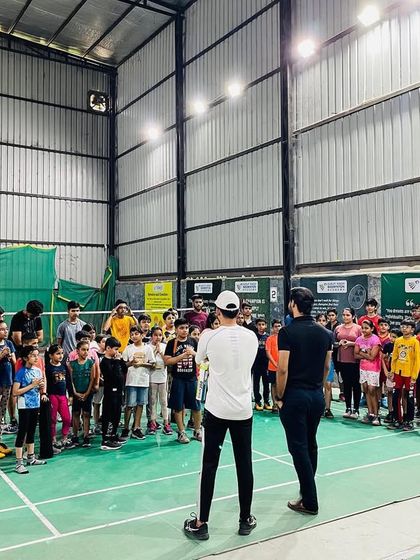 A wide shot of a group talk at the academy. I believe in direct communication and building a strong, unified team spirit among all my players.