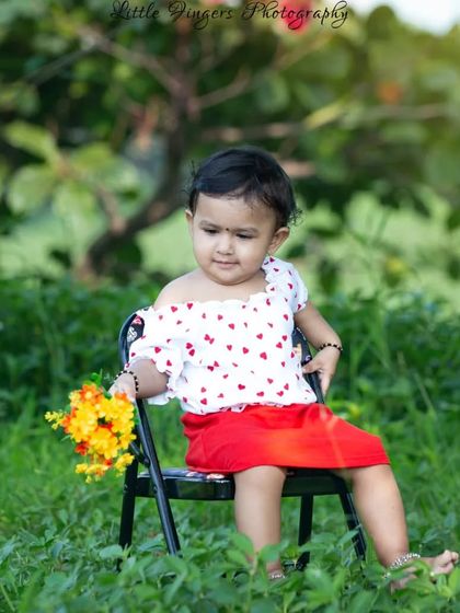 This little lady looks so sweet and thoughtful, sitting with her flowers in the tall green grass. I love finding these quiet, beautiful spots in nature for my children's portrait sessions.