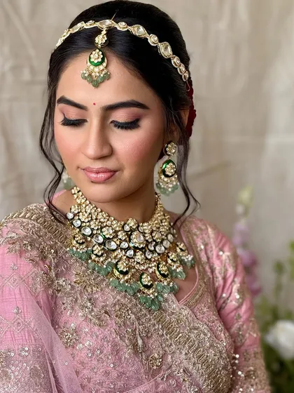 A close-up of this bride's soft pink makeup look. The eyeshadow is blended beautifully, and the skin has a natural, dewy finish that looks fresh and youthful.