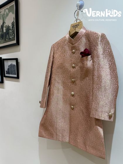 A glimpse of our rose-gold Jodhpuri jacket hanging in the store. The rich, shimmery fabric and classic buttons make this a timeless piece, perfect for creating a mini maharaja look.