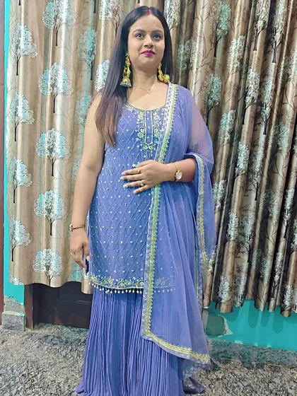 A client posing in the periwinkle blue sharara set, a perfect outfit for a daytime festive event.