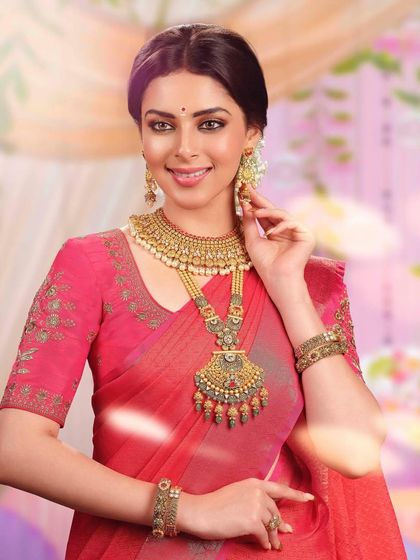 A close-up portrait highlighting another exquisite temple jewelry set. The detailed craftsmanship of the necklace and earrings is the central focus of this bridal look.