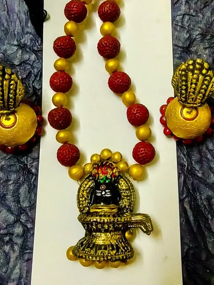 This set is dedicated to Lord Shiva, featuring a Shivalingam pendant and earrings shaped like a 'tripundra'. The rudraksha-style terracotta beads complete the devotional theme.