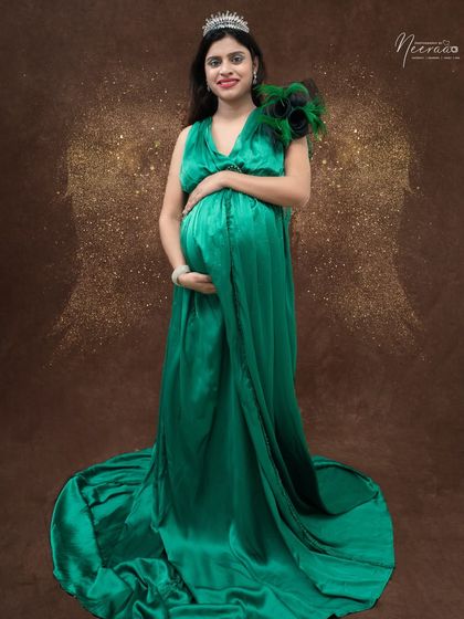 A beautiful portrait with a subtle touch of magic. The golden angel wings and tiara transform this into an ethereal image of motherhood.