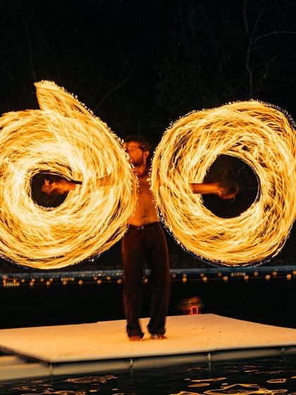 A fire poi artist creates stunning spirals of flame against the night sky. These performances are a highlight of the festival evenings, bringing the community together.