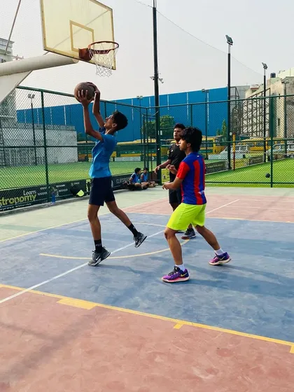 A young player practices a layup during a game drill. We focus on proper footwork and finishing with both hands to make our players versatile.