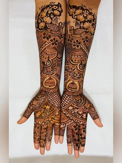 An elegant engagement mehendi with peacocks and floral motifs. This design is intricate enough to feel special but not as heavy as a full bridal look.