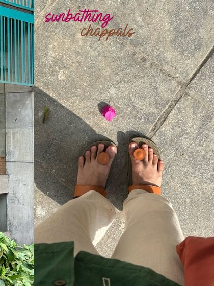 My sunbathing chappals, a quirky self-portrait of my feet on the pavement.