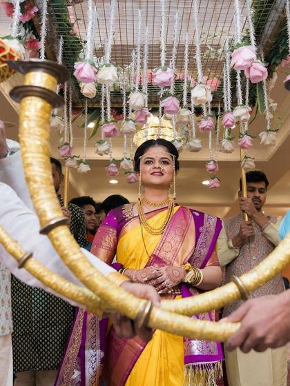 A grand and royal bridal entry. The bride makes her way to the ceremony under a beautiful floral canopy.
