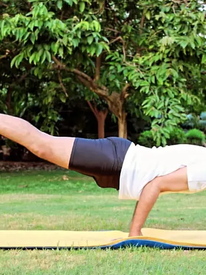 This is Mayurasana (Peacock Pose), an advanced arm balance that requires significant core strength, balance, and focus. It's a powerful demonstration of how consistent practice can train the body and mind to work in complete harmony.