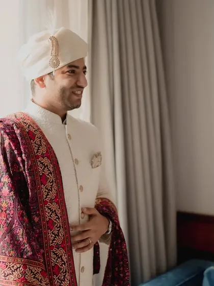 The groom's happy and excited expression just before seeing his bride for their first look. The anticipation is part of the magic.