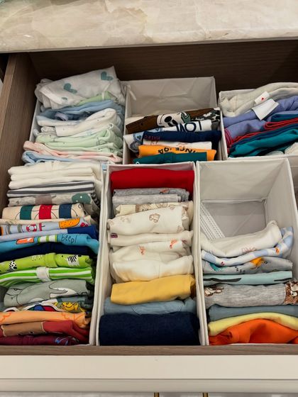 We use drawer dividers to create custom sections for different types of baby clothes, from onesies and pajamas to t-shirts and pants.