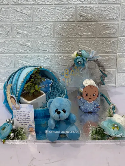 This hamper is a complete gift, combining treats, decor, a plant, and a toy.