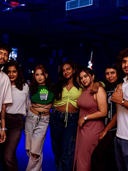 A cool group of friends hanging out by the bar.